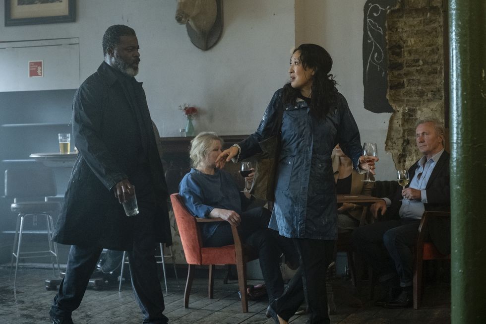 Danny Sapani and Sandra Oh in a scene from 'Killing Eve.' They are having an argument in a bar where Kenny's funeral is being held and Eve is walking away. 