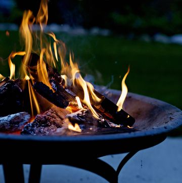 how to keep garden warm in winter, closeup of burning fire pit at night