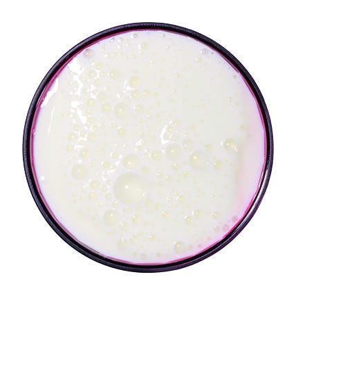red glass pictured from above full of white liquid, kefir