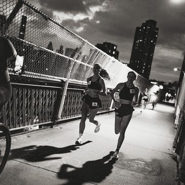 runners participating in a nighttime race on a bridge runners participating in a nighttime race on a bridge