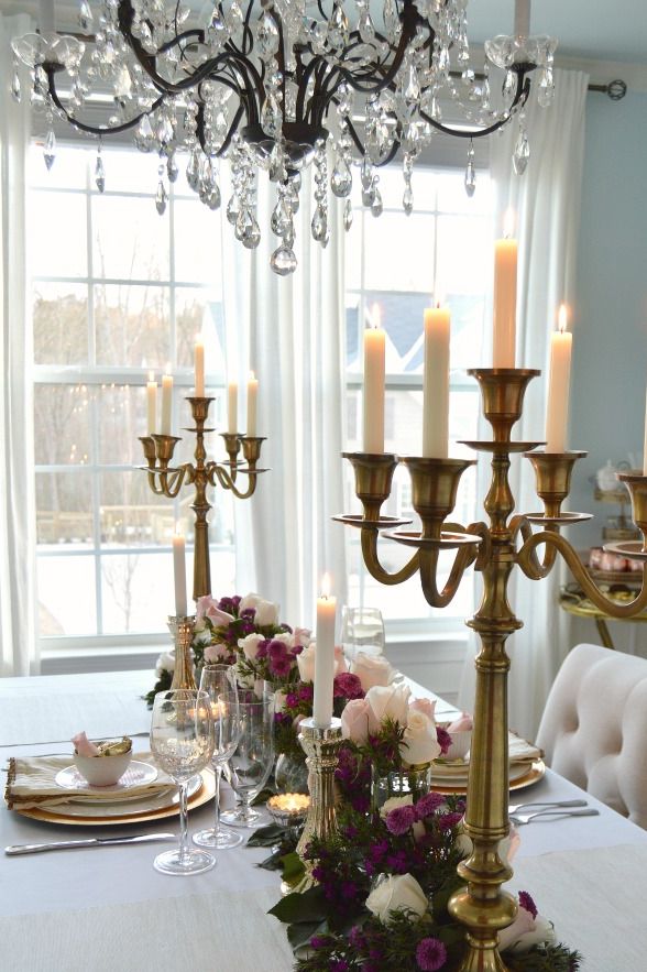 a table with a chandelier and candles on it