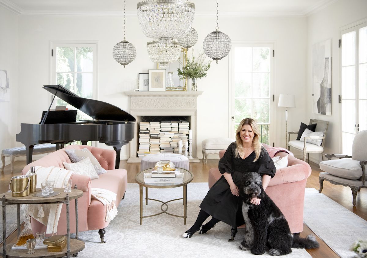 kelly clarkson posing in room with furniture from her wayfair collection