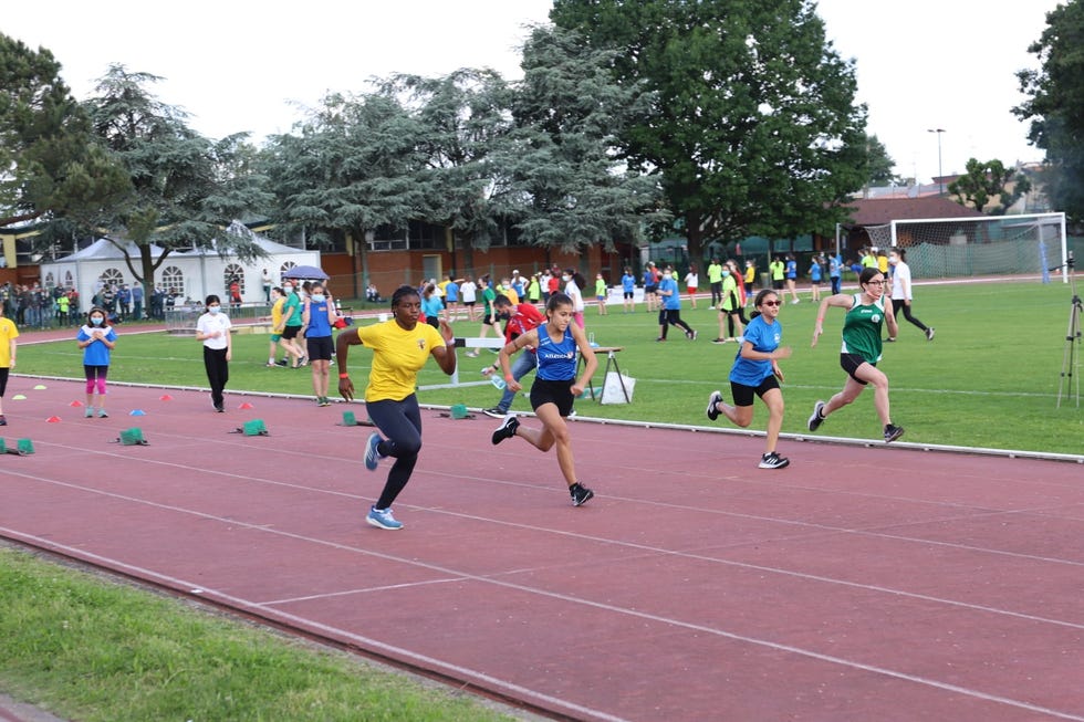 a group of people running on a track