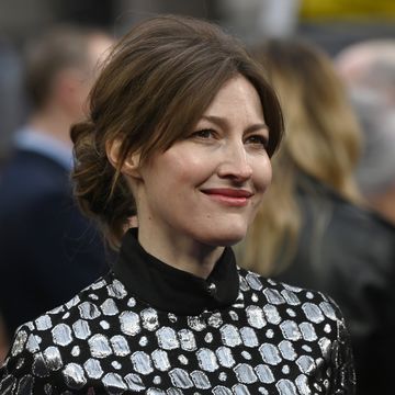 kelly macdonald smiles as she appears at a red carpet event