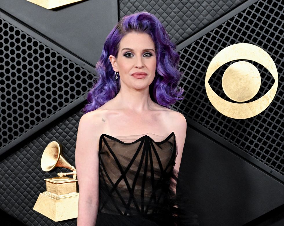 kelly osbourne sports purple hair and a strapless black floor length dress