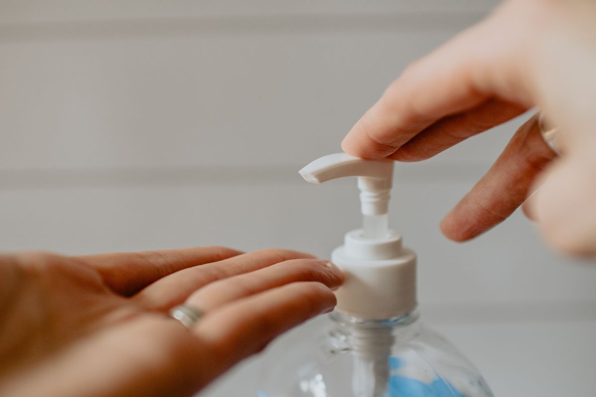 person applying hand sanitizer