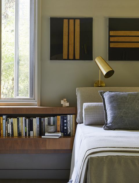 a collection of lucite framed prayer scripts hangs over the bed