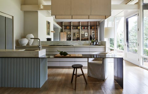 a thin plated steel prep counter extends off the sink to face the den