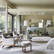 a calacatta marble partition separates the seating area from an open kitchen shielding countertop clutter while inviting conversation between cook and guest