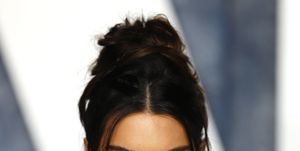 kendall jenner on the red carpet in a gold dress with her hair up