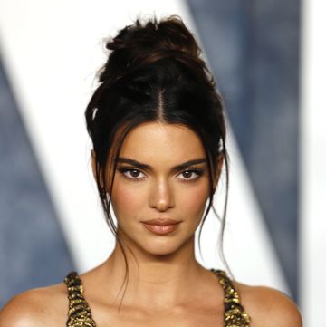kendall jenner on the red carpet in a gold dress with her hair up