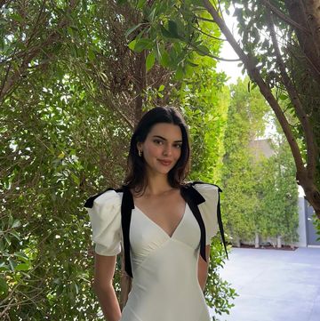 kendall jenner wearing a white coquette dress with black ribbons in a garden for easter