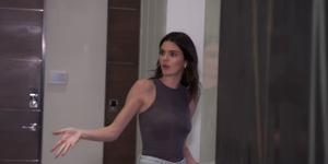 kendall jenner wearing a gray tank top gesturing toward kylie jenner offscreen as they argue about their outfits on 'keeping up with the kardashians'