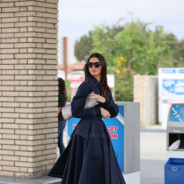 kendall jenner in a denim dress at a petrol station