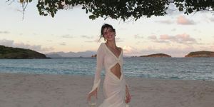 a person in a white dress on a beach