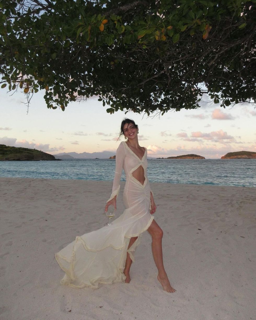a person in a white dress on a beach