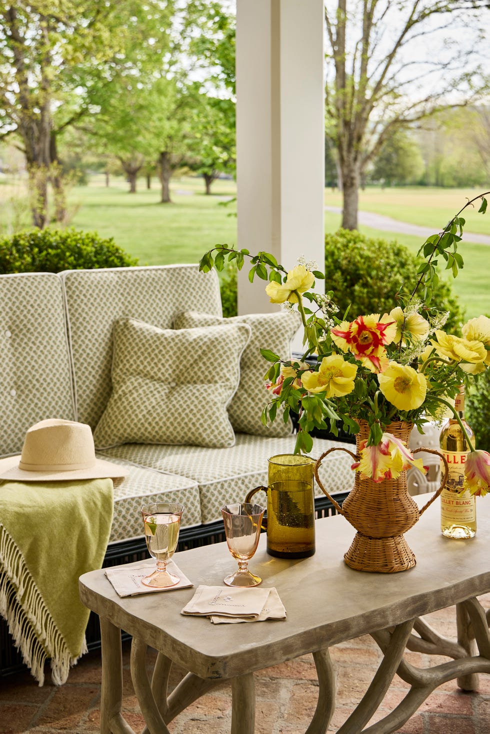porch overlooking golf course with a couch and coffee table
