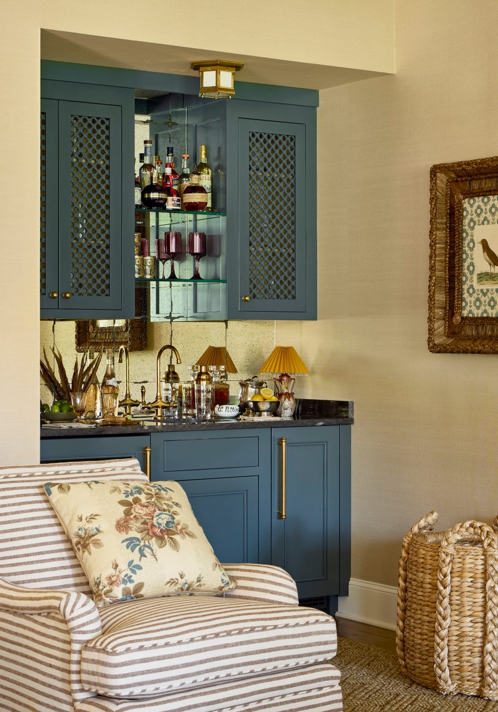 wet bar painted blue with a striped chair in front of it