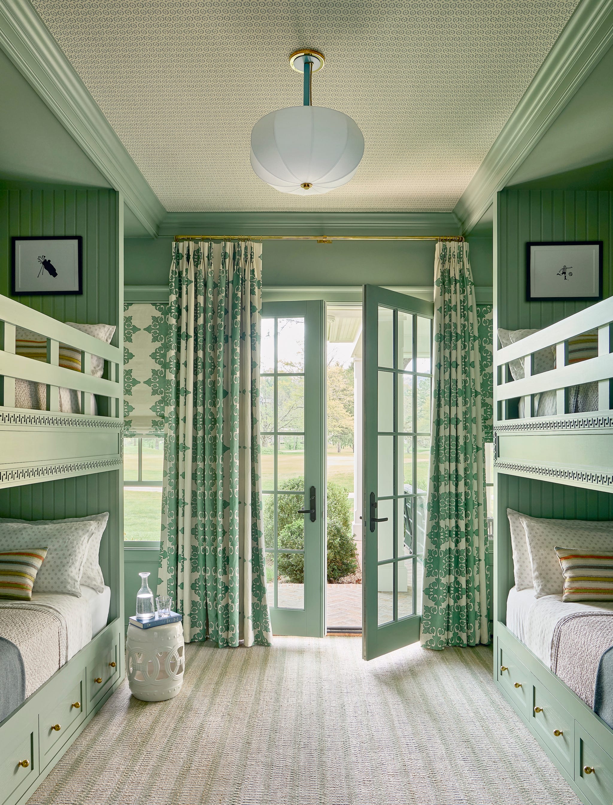 bunk bed room with walls and beds painted green and curtains over doors
