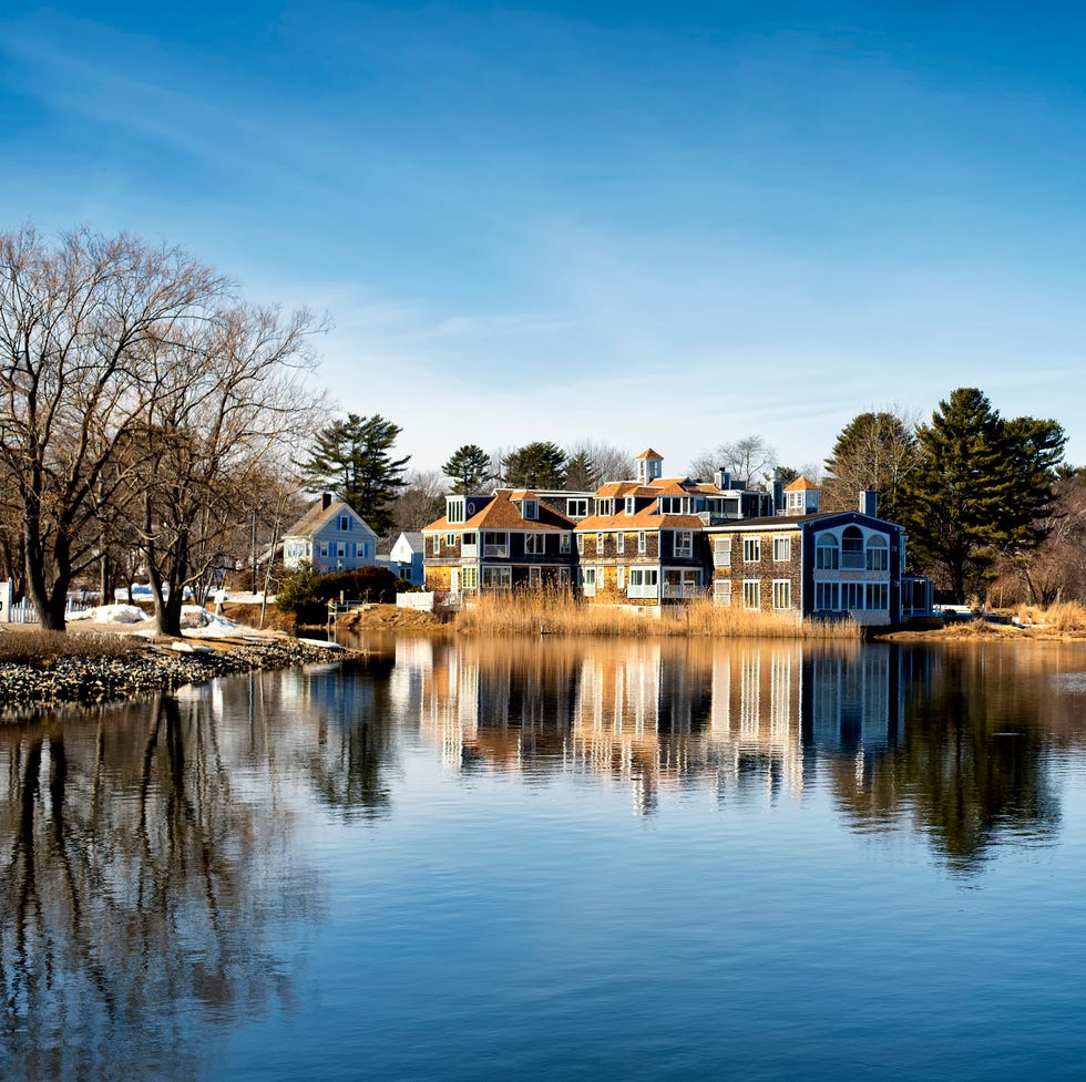 Kennebunkport Maine Mansion on the water a large mansion reflecting off the waters of the batson river in kennebunkport maine on a cold sunny winter day