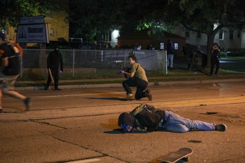 kenosha, wisconsin, usa   august 25 a man on the ground was shot in the chest as clashes between protesters and armed civilians who protect the streets of kenosha against the arson during the third day of protests over the shooting of a black man jacob blake by police officer in wisconsin, united states on august 25, 2020 photo by tayfun coskunanadolu agency via getty images