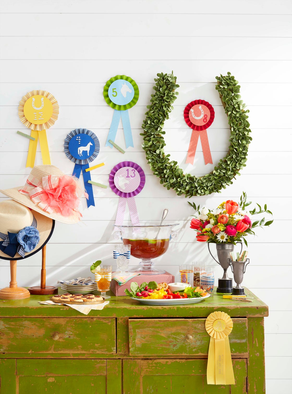 kentucky derby day party kentucky benedictine dip, betting ribbons, hats on vintage stands, horseshoe “wreath”, flowers in vintage trophy “vases”