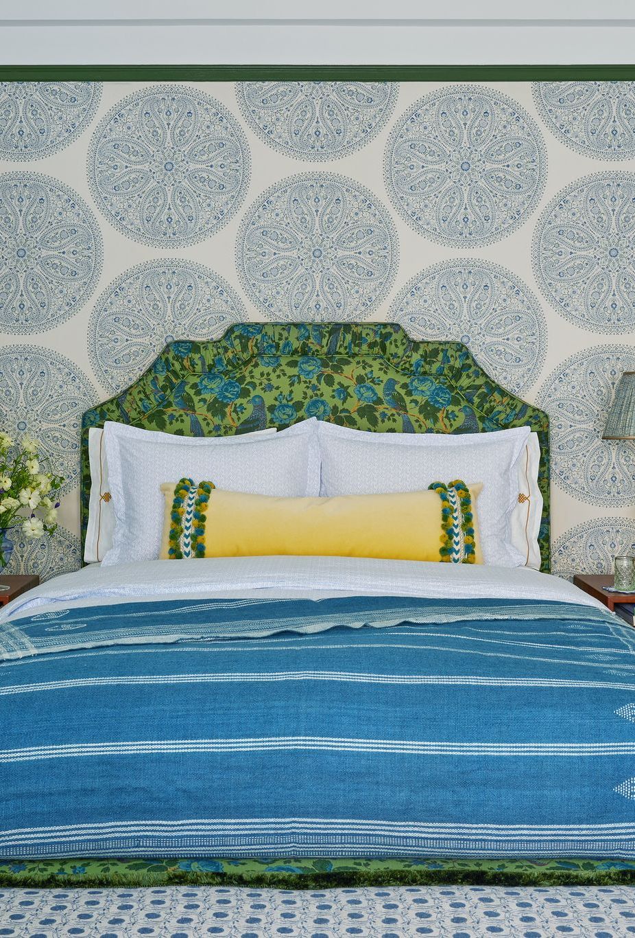 a bed with a blue and yellow comforter