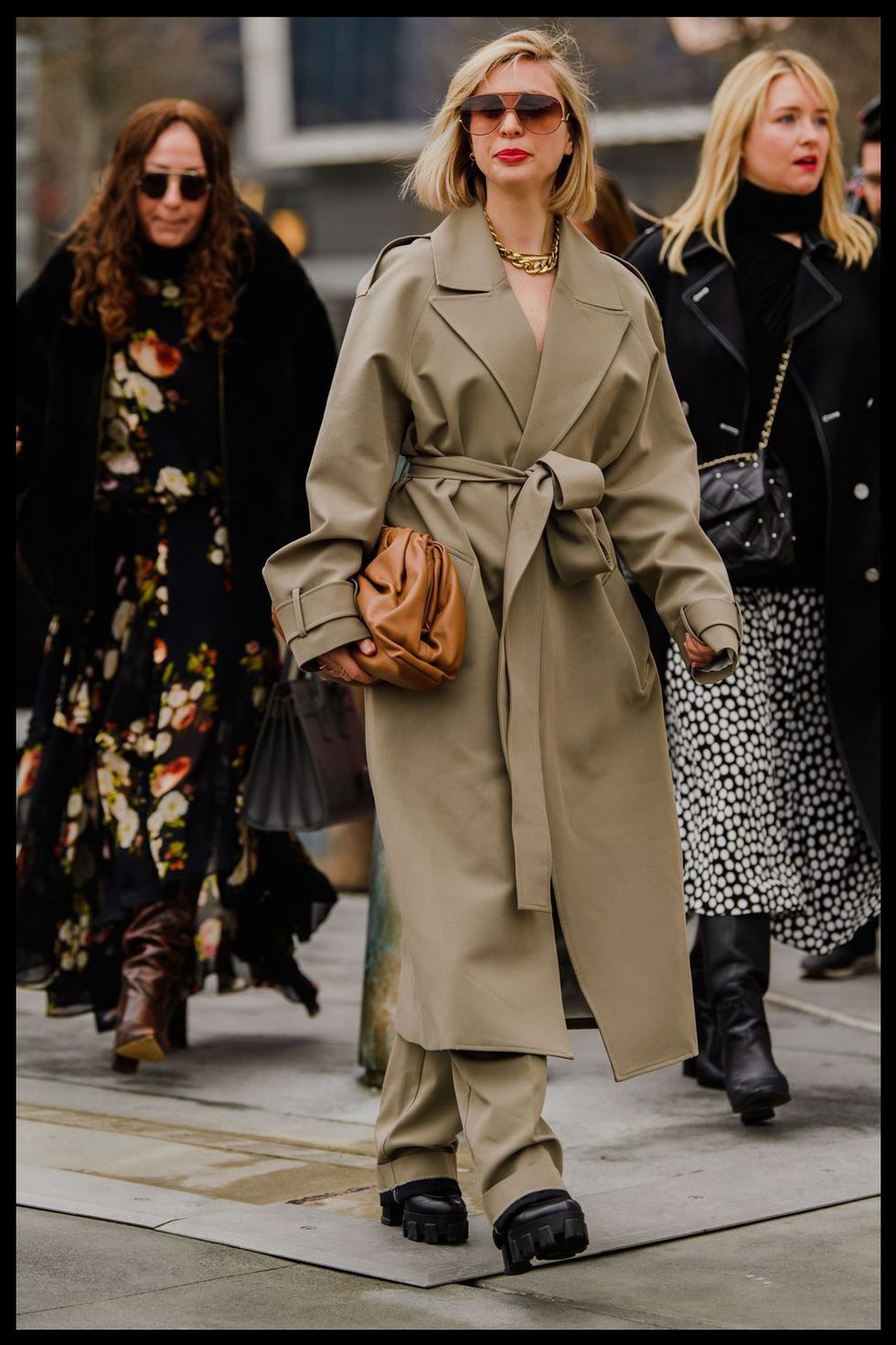 kerry pieri wears a trench coat and trousers at new york fashion week