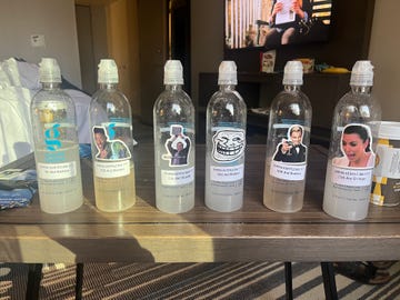 plastic water bottles labeled for various aid stations at a race event