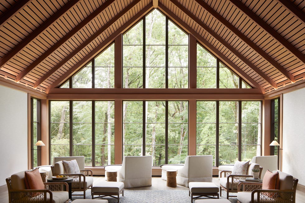 spacious living area with large windows overlooking greenery