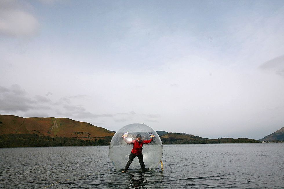 keswick, united kingdom march 24 keswick mountain festival volunteer tara vallente walks on water inside an inflatable sphere on derwent water in the lake district on march 24, 2009 in keswick, england the new floating adventure is one of the hundreds of activities available to the public as part of this years mountain festival which starts on may 13 photo by christopher furlonggetty images