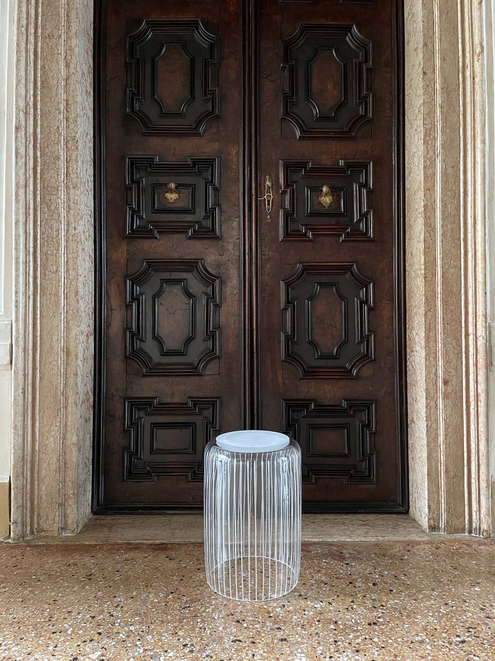 a glass of water in front of a wooden door