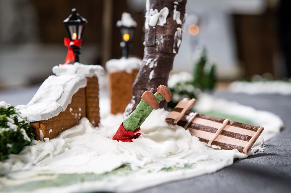 gingerbread kevin mccalister lodged into a snow pile after crashing his sleigh