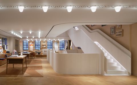 the curved stone staircase of the ﻿hermès flagship store, which runs up all four floors