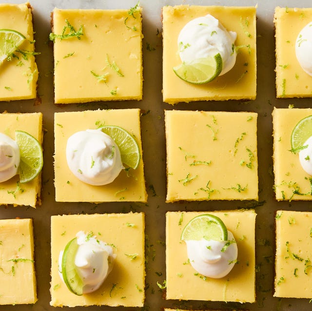 Key Lime Bars key lime bars topped with whipped cream, a lime zest, and a lime wedge