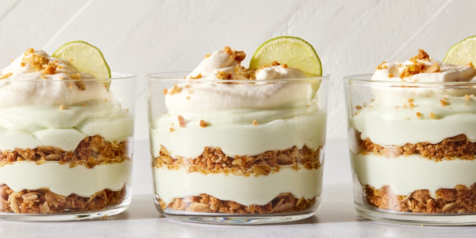 layered key lime pie mousse with whipped cream and a lime
