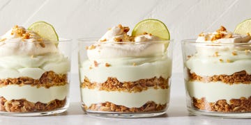 layered key lime pie mousse with whipped cream and a lime