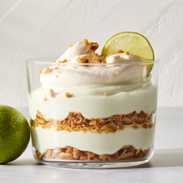 layered key lime pie mousse with whipped cream and a lime