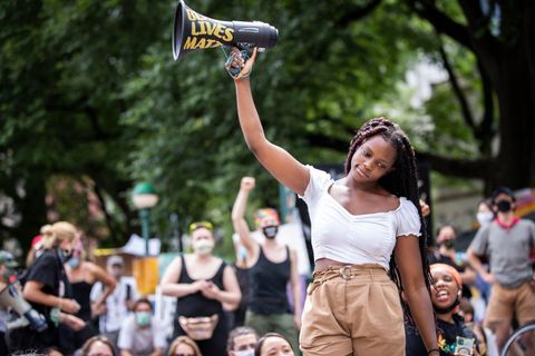 kiara williams, an organization leader of the group warriors in the garden holds up a megaphone as she talks to the crowd that has assembled in the occupy city hall campgrounds in new ﻿york city