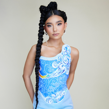 actress kiawentiio poses in a blue mermaid gown