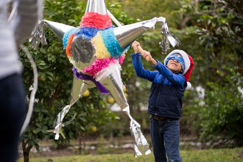 kid hitting a piñata on christmas