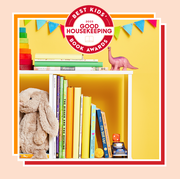 white bookshelf with childrens books and a stuffed rabbit and toys