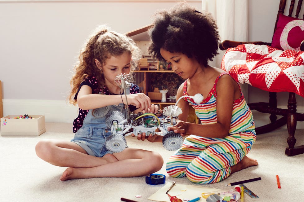 two little girls working to together on a science project