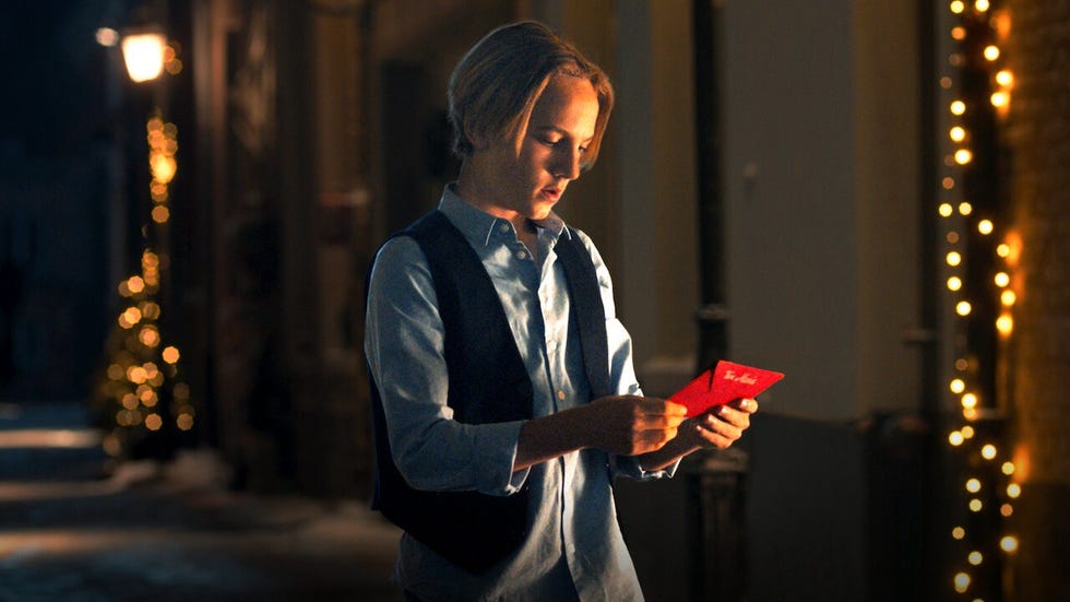 jules holds a letter in a red envelope in a scene from the claus family 2