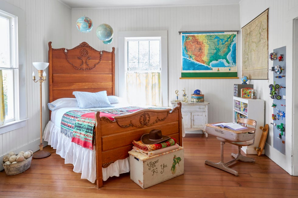 kids bedroom with wood bed and maps on the wall