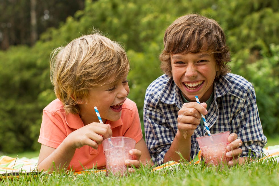 Kids Drinking Milkshakes on Picnic Blanket