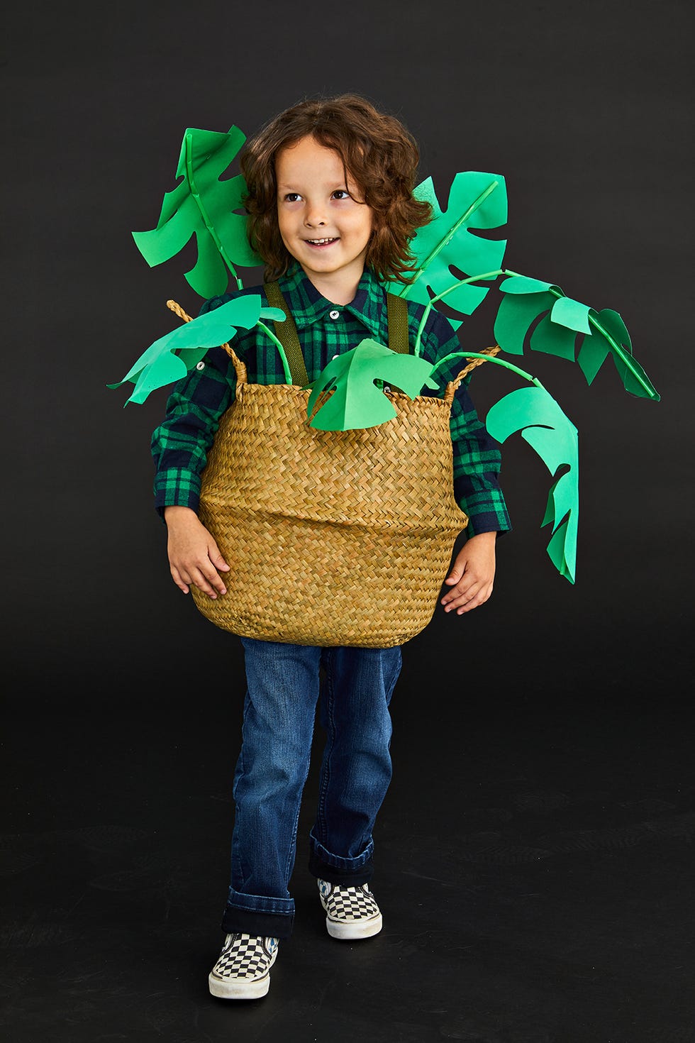 a child wears a diy kids halloween costume that looks like a plant in a planter