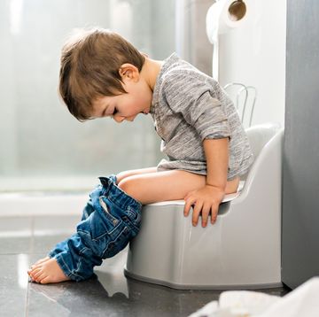 young kid sitting on potty chair