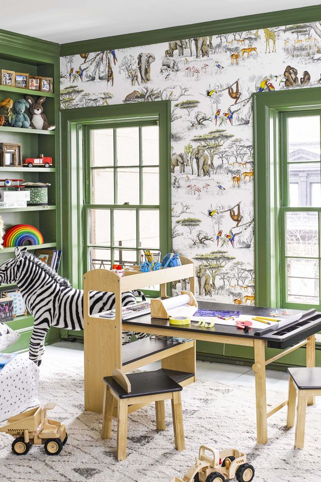 kids room with green paint and black and wood desk