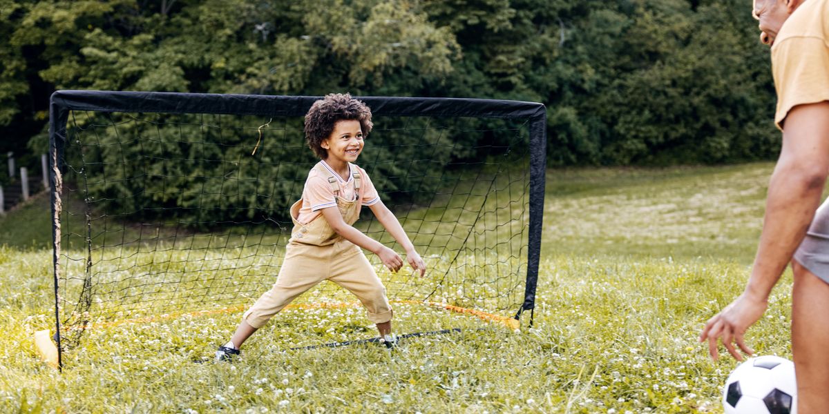 young child defending soccer goal